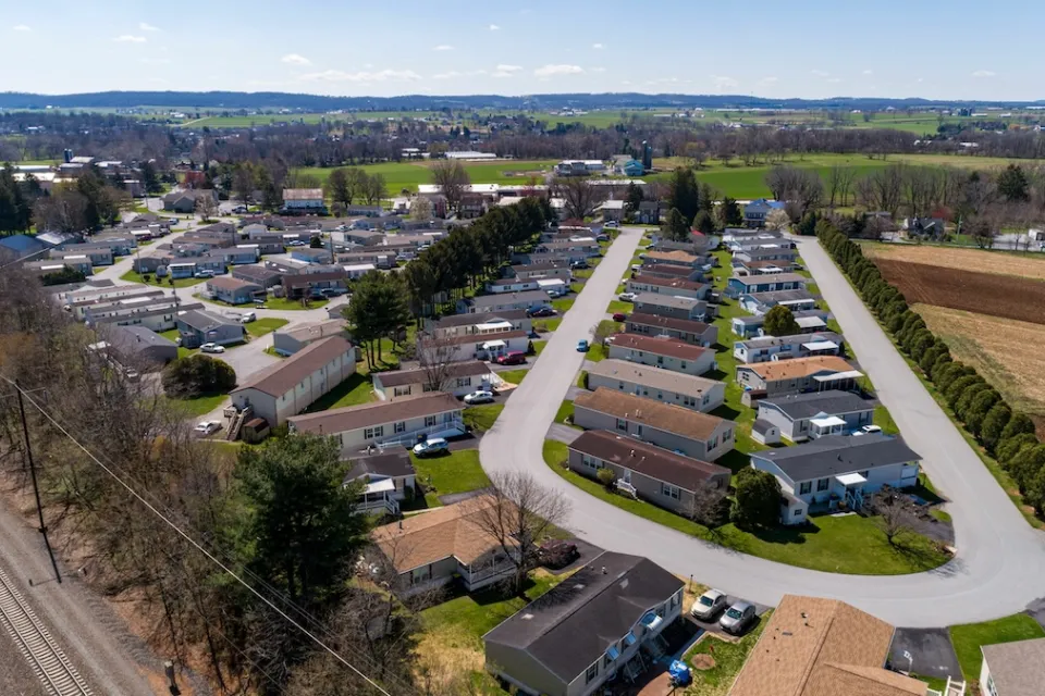 Aerial view of manufactured housing mobile home park in rural area.